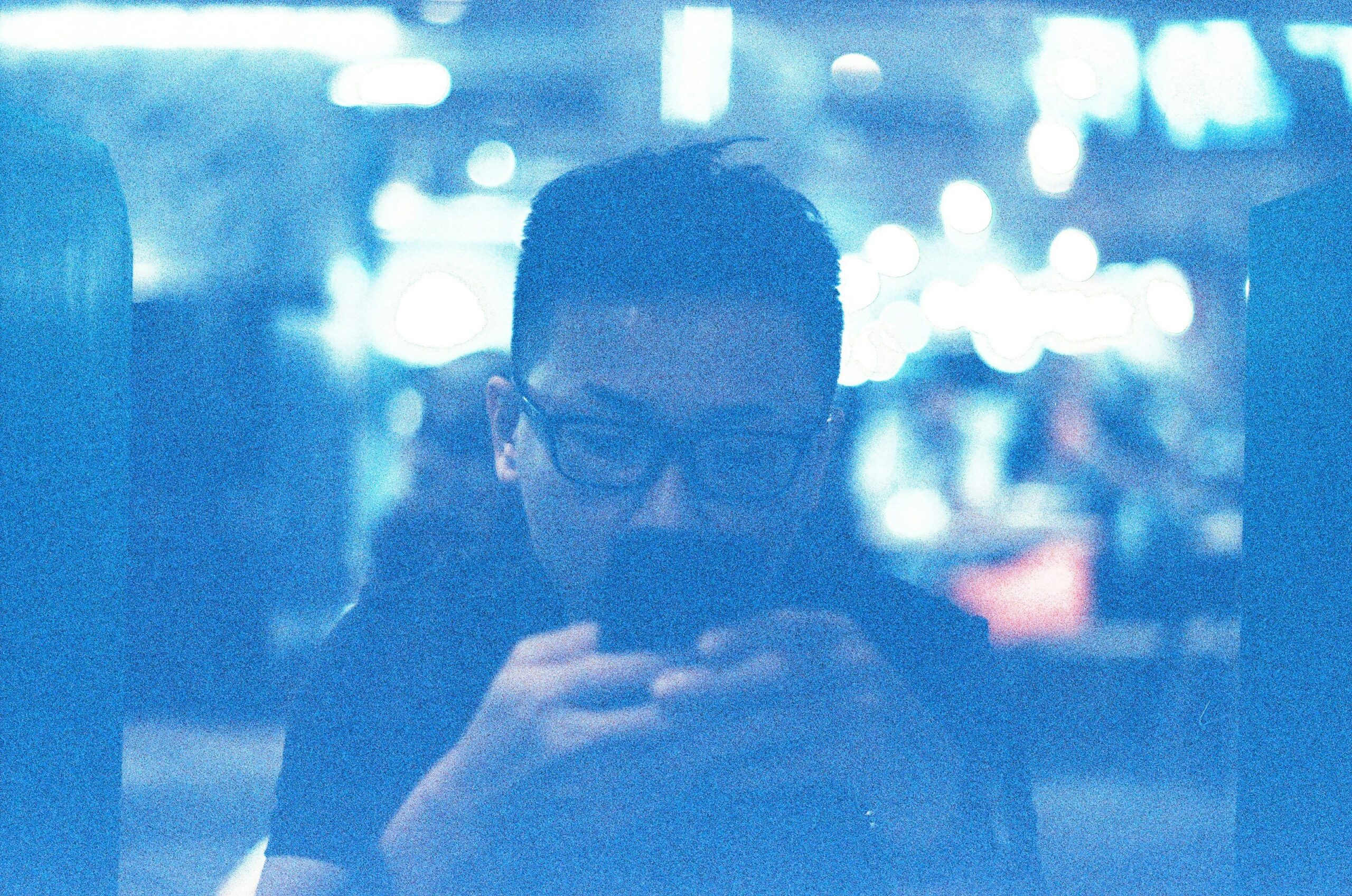 A person overwhelmed by sticky notes scattered across a desk.